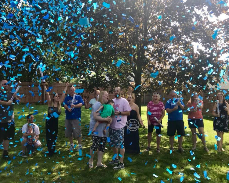 This couple was surprised it was another boy as blue confetti cannons were popped into the air covering them in light blue and shiny blue confetti