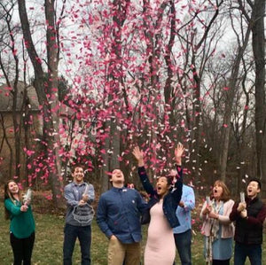 Surprised with our pink confetti cannons, these parents to be are having a girl 